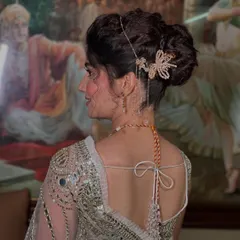 For this bride's Sangeet, I created a romantic and textured updo. The look is elevated with a delicate, dangling hair accessory that adds a touch of sparkle and movement.