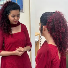 For this client, we embraced her beautiful natural curls with a fiery red balayage. The deep red tones are painted on to enhance the texture and volume of her hair, creating a bold yet elegant look, shown here styled in a high ponytail and also worn down.