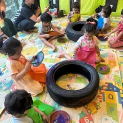 Here's a look at our Transport Week activity in full swing. The kids are using old tires as a canvas, learning about vehicles while engaging in a large-scale, collaborative art project.