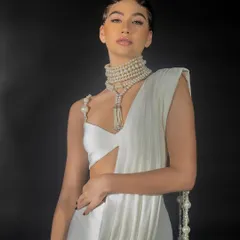 A close-up lookbook shot for Nikhil Thampi. The focus here is on the garment's neckline, the pearl shoulder detail, and the model's beauty look, creating a compelling image for social media and press.