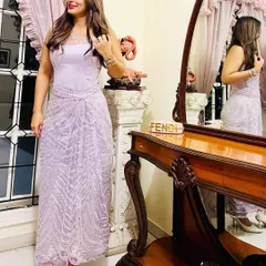A client looking effortlessly chic in our modern cocktail ensemble, featuring a structured satin corset top and a beautifully draped skirt made from beaded lilac fabric.