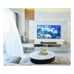 A minimal and modern TV unit design, where a marble feature wall is flanked by a rose gold textured panel and a vertically fluted panel, creating a sophisticated entertainment space.