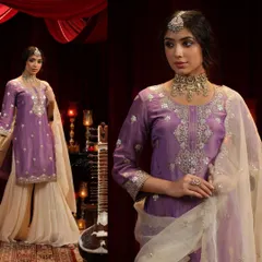 An ode to opulence in lavender and ivory. This sharara set features a regal purple kurta with intricate silver embroidery, paired with wide-legged ivory pants for a beautiful contrast.