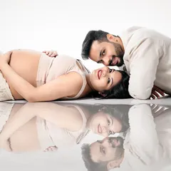 A sweet, reflective moment captured on our mirrored floor. This creative shot shows the couple lying down, creating a beautiful reflection that adds an artistic touch to this minimalist portrait.
