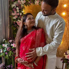 With my husband, sharing a look of love and excitement for our little one to arrive. These are the moments we'll cherish forever.