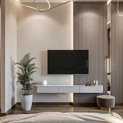 A minimalist bedroom TV unit with a floating console against a fluted panel wall, keeping the space uncluttered and serene.