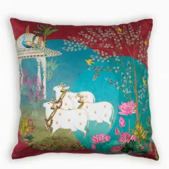 Another design from our Pichwai collection, this cushion depicts a serene pastoral scene with cows and lotuses. The deep maroon and teal color palette adds a touch of regal splendor to the traditional artwork.