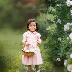 A little lady in the garden. This sweet portrait of a toddler holding a basket of flowers captures the innocence and wonder of childhood. The soft, golden sunset light adds a touch of magic.