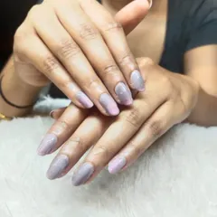 A soft and shimmery ombre effect. This design blends a subtle pink into a sparkling lilac glitter at the tips, creating a delicate and magical look on almond-shaped nails.