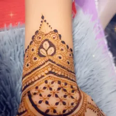 A close-up of a festive design, showing a heart-shaped motif at the wrist. It's the small details that make a design special.