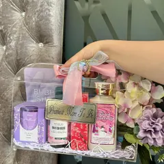 Our luxe acrylic bag hampers are so chic and totally customizable. This one was designed for a special mom-to-be, filled with pampering essentials like lotions, a scented candle, and a bubble sheet mask, all in a pretty purple theme with a custom "Prettiest Mom To Be" tag.