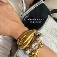 A perfect bracelet stack can make you feel so put together. Here, I've mixed different metals, textures, and styles to create a look that is both bold and personal. This is a small detail that makes a big impact.