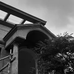 An under-construction view of a French-inspired balcony. This black and white shot highlights the intricate details, proportions, and symmetry that form the foundation of a well-crafted building elevation.