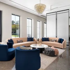 In this seating arrangement, we used deep royal blue chairs to create a striking contrast against the soft, neutral sofas. This demonstrates our approach to using color boldly yet elegantly to define different zones within an open-plan living space.