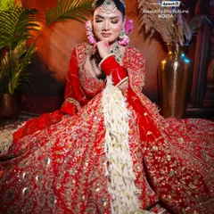 Creating a complete bridal look involves more than just makeup. Here, we focus on the entire presentation, from the floral hair accessories to the way the gajra complements the intricate red lehenga.