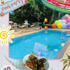 The perfect setup for a birthday pool party. This image captures the fun vibe with colorful balloons, pool floats, and a delicious serving of sesame sizzler sticks ready for guests.