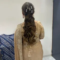 A beautiful wavy ponytail with delicate hairpins. This style is both glamorous and practical, keeping hair neatly styled while adding a touch of sparkle.