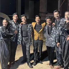 A mandatory backstage picture with our talented backup dancers in their shimmering silver and black costumes, ready to light up the stage for a destination wedding Sangeet.