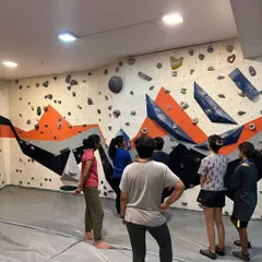 A group of climbers listens to a briefing before starting their session. These workshops are a great place to ask questions and learn in a no-judgment environment.