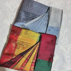 A vibrant multi-colored silk saree and a classic cotton one, both pre-pleated and ready for draping. The pin holds the pleats securely in place until you are ready to wear it.