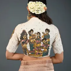 A narrative piece, this blouse features a hand-painted Kalamkari panel depicting a group of celestial women. The off-white fabric provides the perfect canvas for the colorful and detailed artwork.