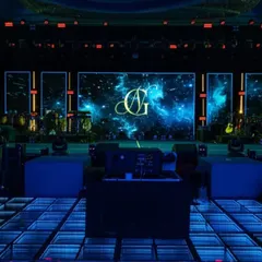 The stage featured a massive LED screen displaying a custom monogram against a galactic nebula. Paired with an infinity-mirror dance floor, the setup provided a dynamic and visually stunning focal point for the night's performances.