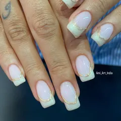 Pearl threads with chrome art. This is a sophisticated French manicure with a shimmery pearl base and a delicate gold chrome line accentuating the tip.