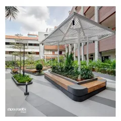 As part of a larger institutional project, we designed this white architectural pergola with a built-in planter and bench seating. It functions as a central meeting point, offering shade and structure within the open courtyard.