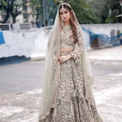 For the modern bride, this pastel green lehenga with detailed threadwork and a matching sheer dupatta is a dream come true. It's perfect for an engagement or a day wedding, complete with a full rental jewellery set.