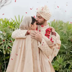 A tender moment between the couple, showered with rose petals after their serene and intimate wedding ceremony.
