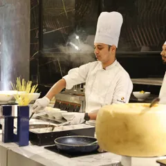 Our live pasta station is pure theatre. A chef prepares fresh pasta, finishing it in a giant wheel of Parmesan cheese, creating an interactive and aromatic experience that captivates guests.