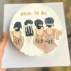 A beautiful example of our whip cream portrait art on a bento cake. This "Bride to be" cake was made for a bridal shower, featuring the bride and her bridesmaids.
