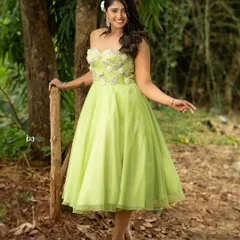 A full-length shot that shows the flow of the dress in a natural setting. This is a great example of an outdoor fashion portrait that feels both elegant and down-to-earth.