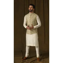 A vibrant lemon-hued Bandi jacket with intricate floral embroidery. Paired with a simple ivory kurta and churidar, this ensemble is designed to bring a fresh and energetic feel to festive daytime events.