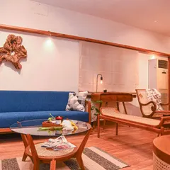 A glimpse into my studio's living area setup, showcasing a range of my work. You can see how the teak sofa, divan, and various tables come together to create a warm, cohesive, and inviting atmosphere.
