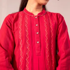 A close-up of the Chikankari embroidery on our red Haveli dress. The tone-on-tone stitching creates a subtle, elegant texture that is both traditional and modern.