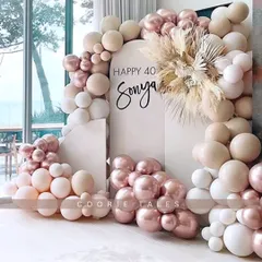 Marking a milestone 40th birthday with style and sophistication. This chic setup uses a trendy palette of rose gold, beige, and white balloons, with dried pampas grass for a modern boho touch.