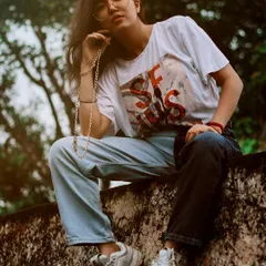 For this lifestyle fashion shoot in Bharatpur, we used the texture of a rustic wall as our backdrop. The model is posed naturally, sitting on the wall, which creates an authentic and relaxed feel, showcasing how personal style can blend with heritage locations.
