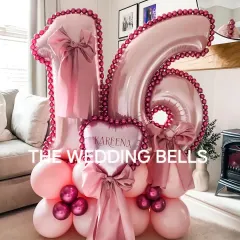 Our custom number balloon bouquets are a huge hit for milestone birthdays. This 'Sweet 16' arrangement in shades of pink features a personalized heart balloon and is adorned with the viral satin bows for an extra touch of style.