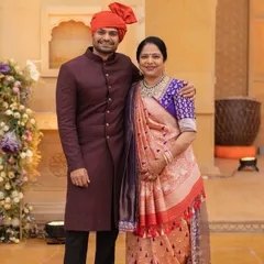 A portrait of the brother of the bride with his mother. We styled him in a rich maroon sherwani that complements his mother's beautiful saree, creating an elegant family look.