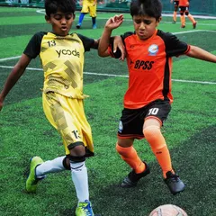 Here you can see the determination of our Under-9 players during a KSFA Youth Premier League match. Even at this age, I teach them the importance of challenging for the ball with fairness and respect.