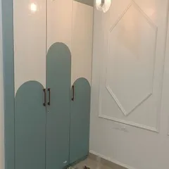 A custom wardrobe from our ATS Rhapsody project. This design features a playful two-tone finish with curved patterns, adding a unique and modern touch to the bedroom.
