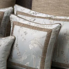 The pillows from our Essential Grey Jacquard set, showcasing the elegant botanical pattern and contrasting textured border, crafted for modern living.