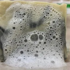 The satisfying, rich lather of our Charcoal & Dead Sea Mud Soap. This bar is formulated to provide a deep cleanse, drawing out impurities while being gentle on the skin.