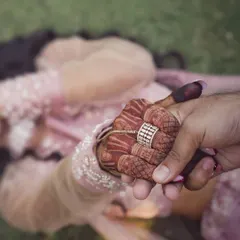The beauty of a wedding is in the details. This close-up shot highlights the intricate henna and the joining of hands, symbolizing a new bond. We take an artistic approach to detail photography, finding creative ways to capture the elements that make your celebration unique.