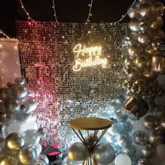 The shimmer wall reflects the party lights, adding energy and sparkle to this outdoor birthday setup.