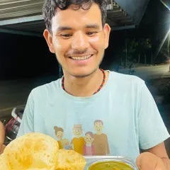 A happy customer enjoying our freshly made, phooli phooli (puffed up) pooris. That smile says everything about how good simple, well-made food can feel.