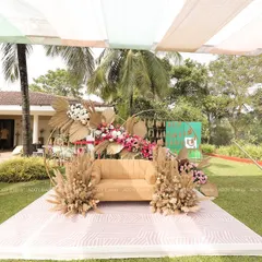 This is a wider perspective of our boho-chic Mehndi seating, showing how it integrates into the beautiful lawn setting. The setup provides a dedicated, stylish space for the main ceremony while maintaining an open and airy feel.