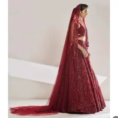 The drama of a full-trail bridal lehenga is undeniable. This all-red, sequined creation by Seema Gujral is for the bride who dreams of a grand entrance. My styling focuses on the magnificent silhouette, keeping the look powerful and unapologetically glamorous.