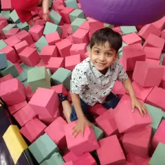 Look at that happy face. Our soft foam pit is perfect for kids who love to jump, tumble, and land softly. It's a great way for them to burn off energy and build confidence in a cushioned, safe space.